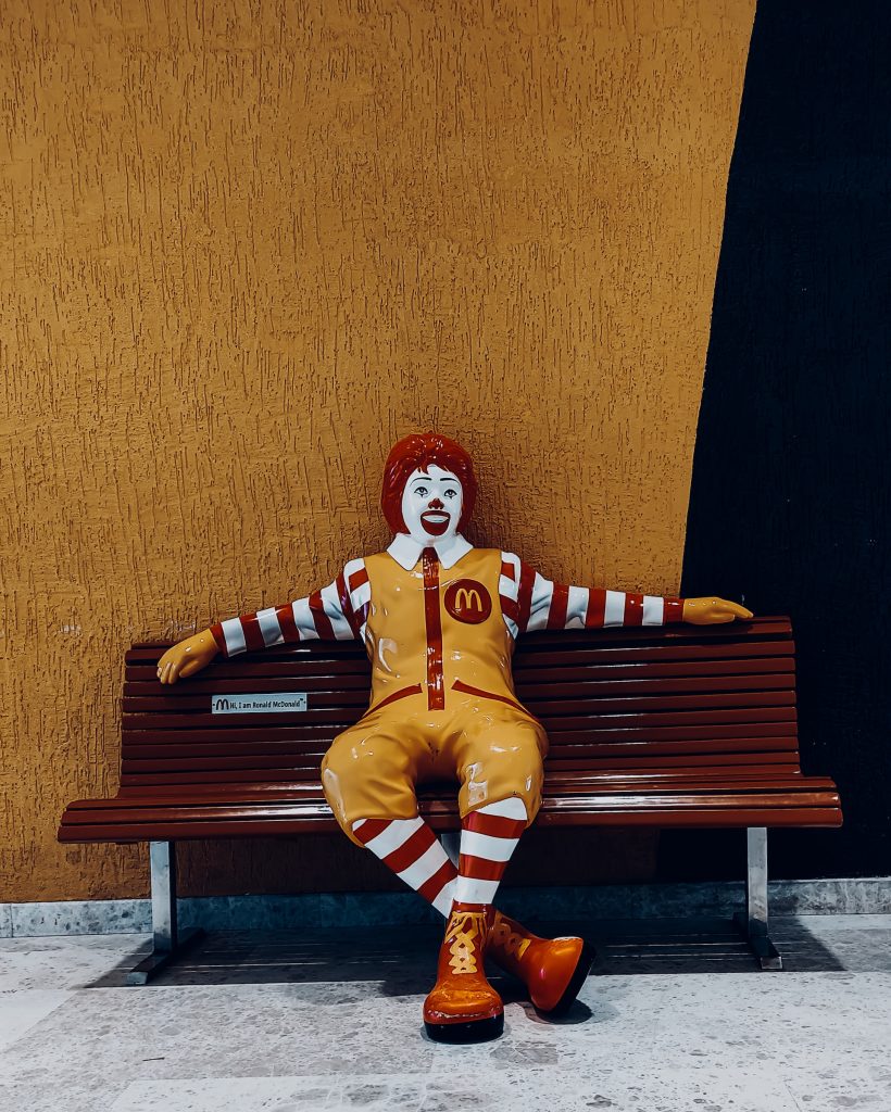 Le clown Ronald McDonald assis sur un banc