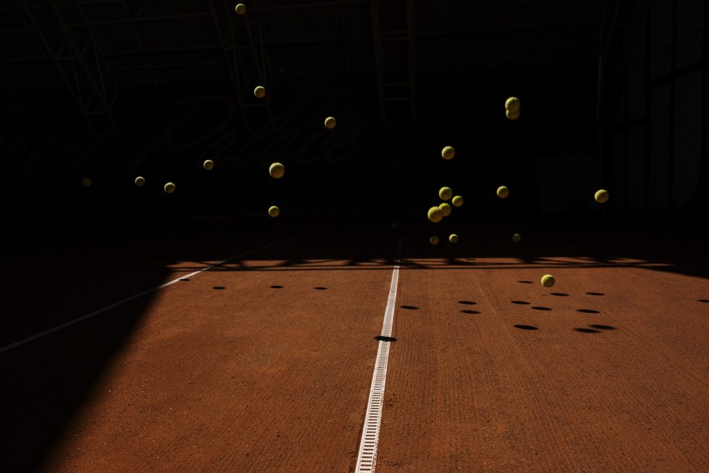 Des balles de tennis en train de rebondir sur un terrain de tennis.